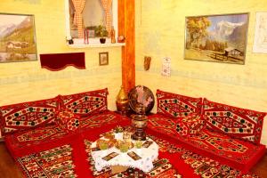 a bedroom with two beds and a table with a lamp at Sebilhan Apart Hotel in Sarajevo