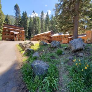 a large log cabin with rocks in front of it at Eagle Cap Chalets in Joseph