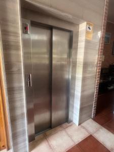 an elevator in a building with a metal door at Hotel Gavitu in Celorio