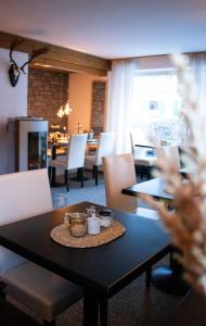 a dining room with a table and chairs and a fireplace at Gästehaus Germania in Schönau am Königssee