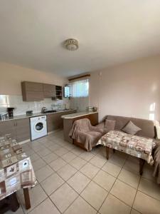 a living room with a couch and a kitchen at MARY in Stepʼanavan +27 photos