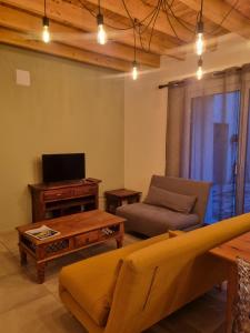 a living room with a couch and a table at bienvenue chez nous in Monstéroux-Milieu