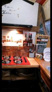 a kitchen with a stove top in a kitchen at Cabaña en la Calera BersaNina in La Calera