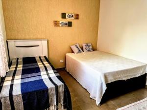 卡拉瓜塔圖巴的住宿－Praia Martin de Sá SP.，一间卧室,配有两张床