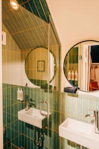 a bathroom with two sinks and a mirror at Somewhere Inn Collingwood in Collingwood