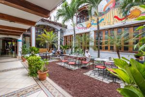 a courtyard with tables and chairs in a building at Socialtel Granada in Granada