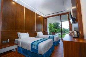 Postel nebo postele na pokoji v ubytování Nirvana Hotel Resort Tetebatu