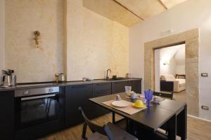 a kitchen with a table and a dining room at Makó House - in centro città in Andria