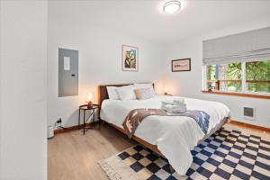 a bedroom with a large bed and a window at Perch - Serenity Nest in Ashford