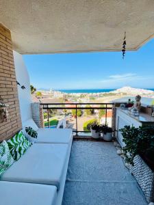 a white couch on a balcony with a view of the ocean at Mirador mar-BookApartments in Peñíscola