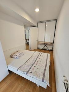 a bedroom with a bed and a large mirror at Apartment S&M in Banja Luka