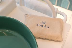 a bag sitting on a table next to a plate at CALEA Boutique Hotel in Bacoli