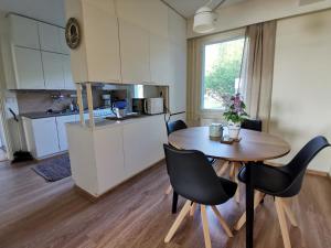 a kitchen and dining room with a table and chairs at Vuori Camp by Saimaa in Vuoriniemi +36 photos