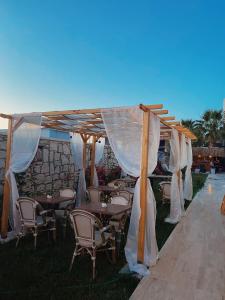 an outdoor wedding with tables and chairs under a tent at Limon Hotel in Çeşme