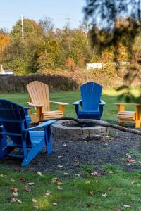 a group of chairs sitting around a fire pit at The Marigold PEC Family Farmhouse country escape in West Lake