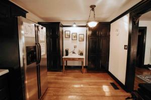 a kitchen with a refrigerator and a table in it at Fairy House by Eden Crest in Sevierville +28 photos