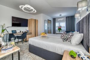 Pokój hotelowy z dużym łóżkiem i biurkiem w obiekcie Acodomo Apartamenty w mieście Poddębice