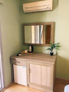 a room with a counter with a mirror and a plant at Limon Hotel in Çeşme