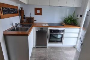 a kitchen with a sink and a stove at Apartment 1 - Haddin Court - Executive One Bedroom in Blenheim +4 photos