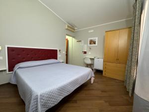 a bedroom with a large bed and a desk at Borgo Manfria in Gela
