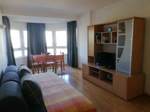 a living room with a couch and a flat screen tv at Holaias Holidays in Lisbon