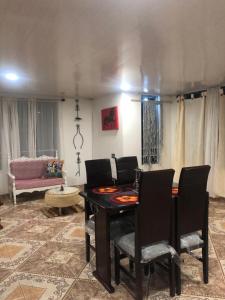 a living room with a table and chairs and a couch at Casa Puente de Boyaca in Tunja