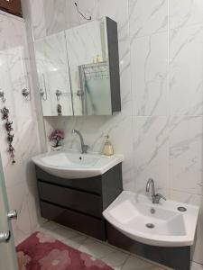 a white bathroom with a sink and a mirror at Zeytinlik Nature House in Akcaabat