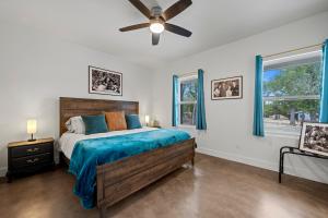 a bedroom with a bed and a ceiling fan at Terracotta Bliss Wimberley Retreat For 28 Guests in Wimberley +169 photos