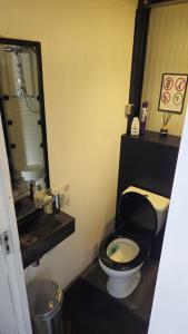 a bathroom with a black toilet and a sink at Boathouse Amsterdam in Amsterdam