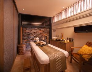 a bedroom with a bed and a brick wall at Bastión Luxury Hotel in Cartagena de Indias +91 photos