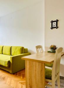 a living room with a table and a couch at Apartment Welcome in Bar