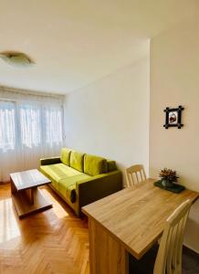 a living room with a couch and a table at Apartment Welcome in Bar