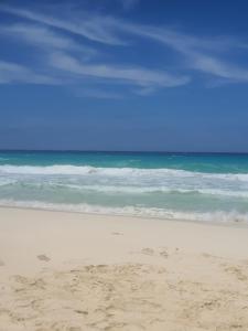 a sandy beach with the ocean in the background at بيت العز للشقق الفندقية - علم الروم Bet Elezz Apartments-Alam Elrom in Marsa Matruh +6 photos