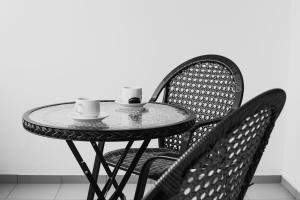 a table with two chairs and two cups on it at Xenion Ioannina in Ioannina