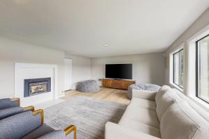 a living room with a couch and a tv at Morning Star Retreat in Vashon