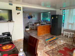 a kitchen with a black refrigerator and a table at Casa Puente de Boyaca in Tunja +14 photos