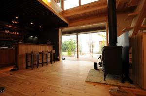 una sala de estar con estufa de leña. en 阿蘇熊本 木の香の家 OMOYA - Aso Kumamoto Airport Timber House "KONOKA NO IE OMOYA", en Nishiharamura