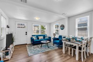 a living room with a blue couch and a table at Highly Rated Beach House 3 5 Blocks from the Beach in Belmar