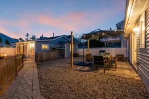 a patio with a table and an umbrella at Highly Rated Beach House 3 5 Blocks from the Beach in Belmar