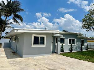 a small white house with a palm tree at Miami Luxury Home Rental in Miami