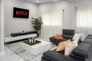 a living room with a couch and a tv at Miami Luxury Home Rental in Miami