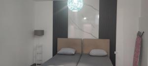 a bedroom with a bed with two pillows on it at V&J apartments in Podgorica