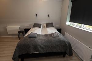 a bedroom with a bed with two pillows on it at Dis Cottages in Grundarfjordur