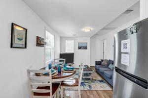 a kitchen and living room with a table and a refrigerator at Cozy 2BR Getaway Just 3 5 Blocks to Beach & Boards in Belmar