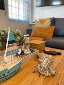 a living room with a toy boat on a table at Flamink Beach View Cottage in Paternoster in Paternoster