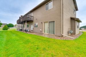 a house with a green lawn in front of it at Cozy Sioux Falls House - Walk to Park! in Sioux Falls