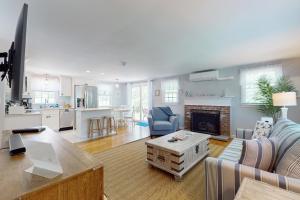 a living room with a couch and a fireplace at Far Away by the Sea in Yarmouth