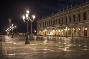 a street light in front of a building at night at Apostoli Palace in Venice +21 photos