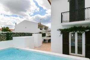 a villa with a swimming pool and a house at FLH Altura Family House with Pool in Altura