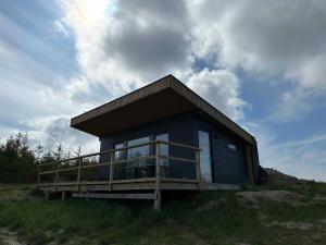 a small house on top of a hill at Cozy Tiny House In Nature - Holiday Home D in Sejerby +18 photos